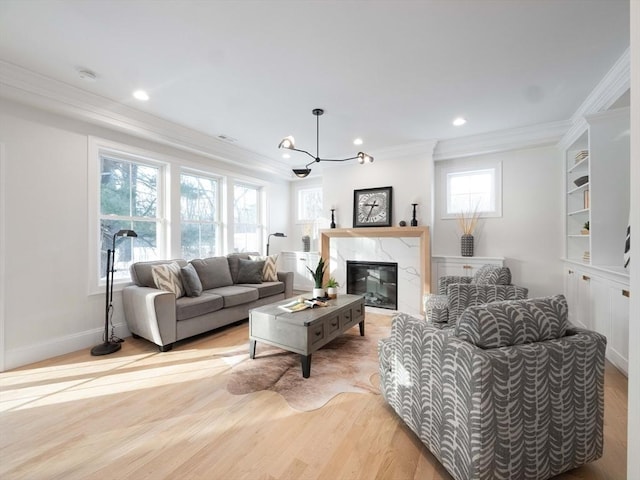 7 Brookdale Rd, Natick, MA 01760 - living room featuring light wood-type flooring, ornamental molding, recessed lighting, and an inviting chandelier