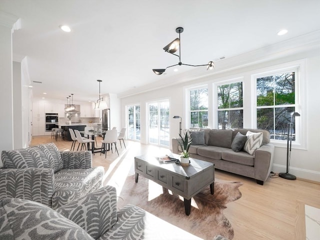 7 Brookdale Rd, Natick, MA 01760 - living room with crown molding, recessed lighting, a chandelier, and a healthy amount of sunlight
