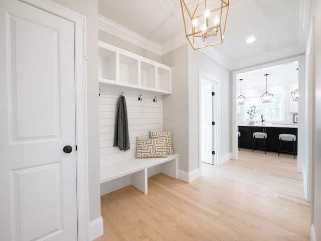 7 Brookdale Rd, Natick, MA 01760 - mudroom featuring crown molding, baseboards, a notable chandelier, and light wood-style flooring