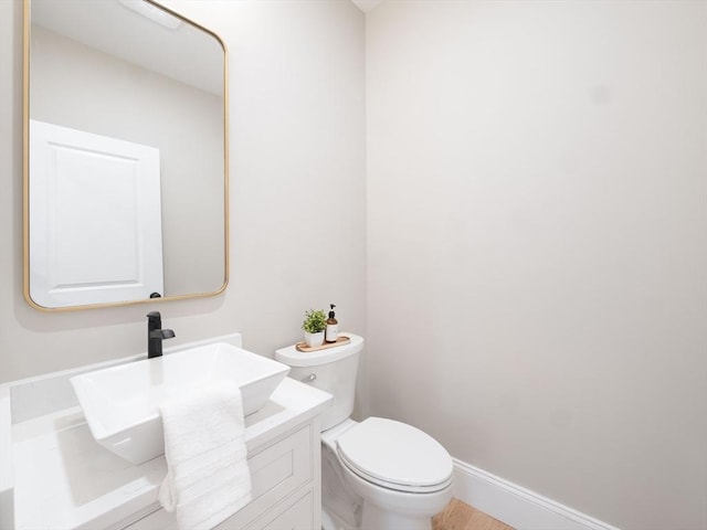 7 Brookdale Rd, Natick, MA 01760 - bathroom featuring toilet, baseboards, and vanity