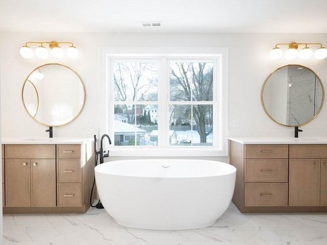 7 Brookdale Rd, Natick, MA 01760 - bathroom featuring a healthy amount of sunlight, visible vents, two vanities, and marble finish floor
