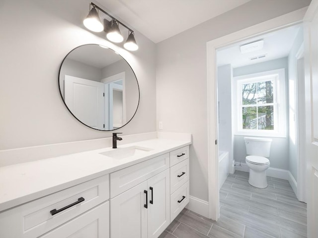 7 Brookdale Rd, Natick, MA 01760 - full bath with vanity, baseboards, visible vents, and toilet