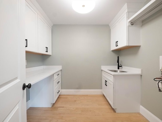 7 Brookdale Rd, Natick, MA 01760 - laundry area with baseboards, a sink, and light wood finished floors