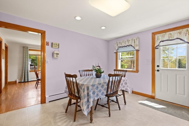 dining space featuring a baseboard heating unit, plenty of natural light, recessed lighting, baseboards, and light tile patterned floors