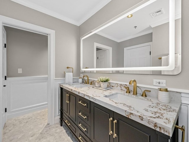 92 Warren St Unit W-1, Boston, MA 02129 - bathroom featuring double vanity, crown molding, and a wainscoted wall