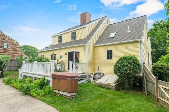 2 Dewey St, Amesbury, MA 01913 - back of property with a wooden deck, roof with shingles, and a chimney