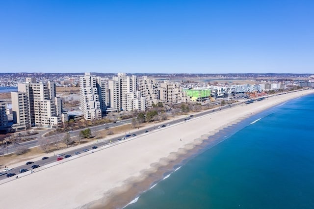 bird's eye view featuring a view of the beach and a water view