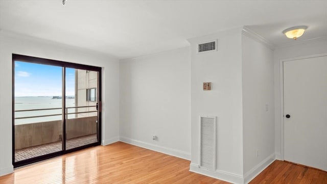 interior space with light hardwood / wood-style flooring and a water view