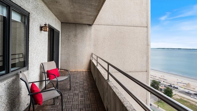 balcony with a view of the beach and a water view