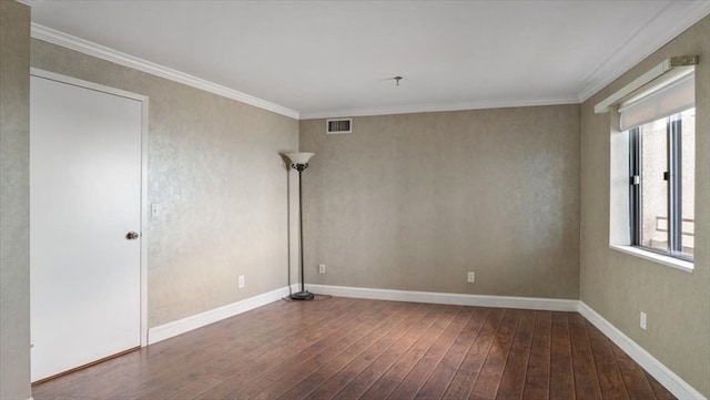 empty room featuring plenty of natural light, hardwood / wood-style floors, and ornamental molding