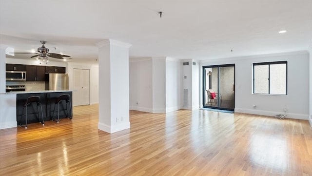 unfurnished living room with ceiling fan, light hardwood / wood-style floors, and ornamental molding