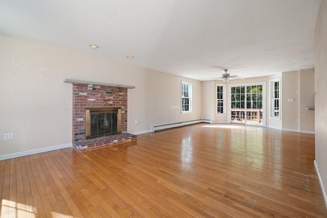 unfurnished living room with a fireplace, hardwood / wood-style floors, baseboards, and a baseboard radiator