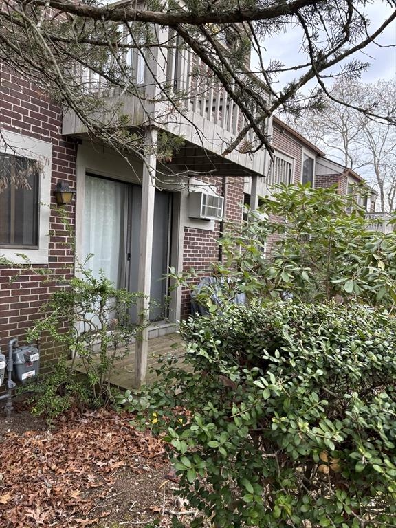 view of home's exterior with cooling unit and brick siding
