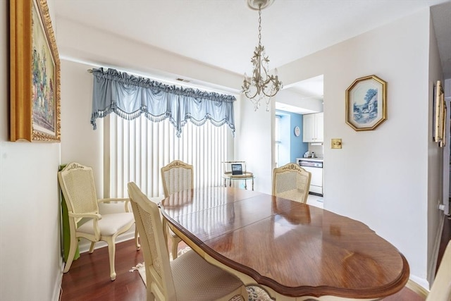 dining room with a notable chandelier, wood finished floors, and baseboards