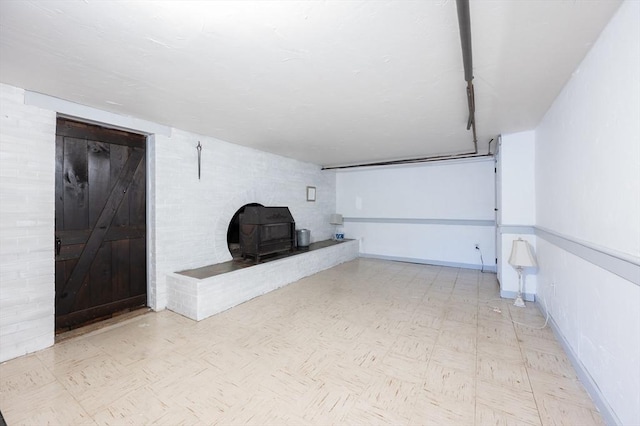 interior space with a wood stove and baseboards