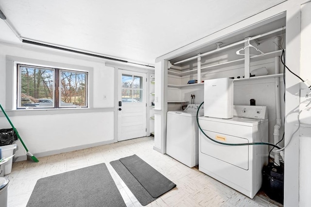 washroom with laundry area, independent washer and dryer, and light floors