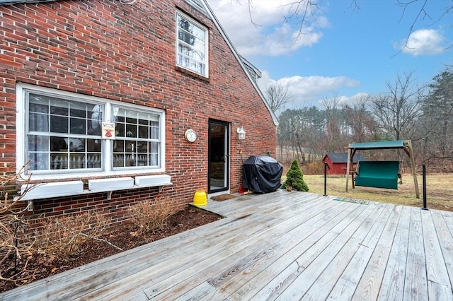 wooden terrace featuring a grill