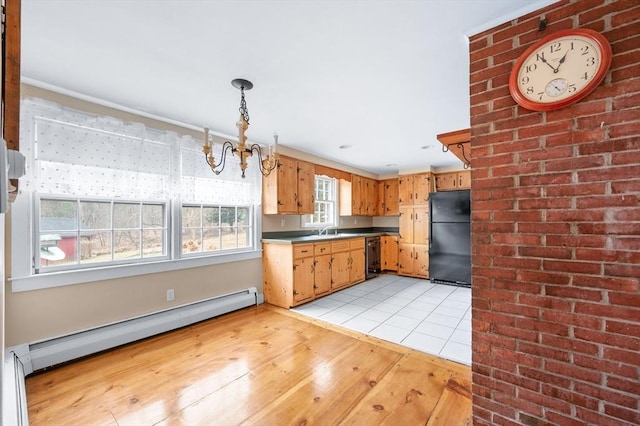 kitchen featuring a chandelier, a baseboard radiator, a sink, light wood-type flooring, and black appliances