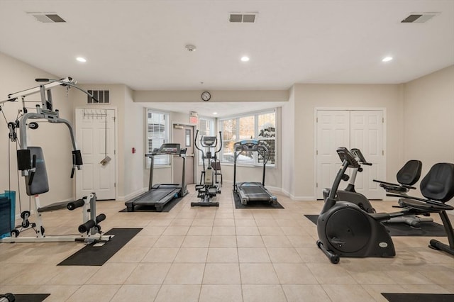 workout room featuring light tile patterned floors