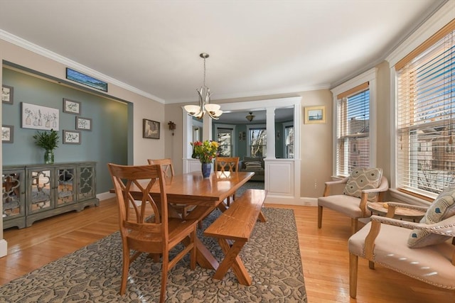28 Fletcher St Unit 1, Boston, MA 02131 - dining area featuring a chandelier, crown molding, light wood-style flooring, and baseboards