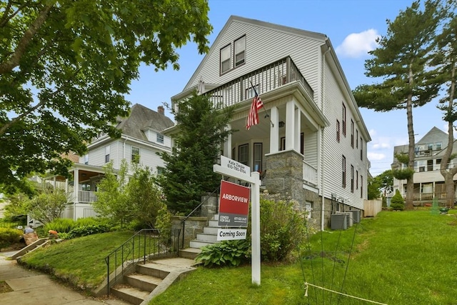 28 Fletcher St Unit 1, Boston, MA 02131 - view of front of home with a front yard, central air condition unit, and a balcony
