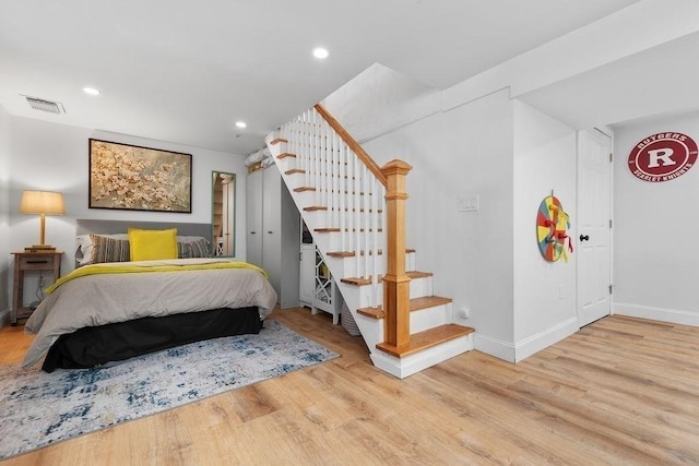 bedroom featuring recessed lighting, wood finished floors, visible vents, and baseboards