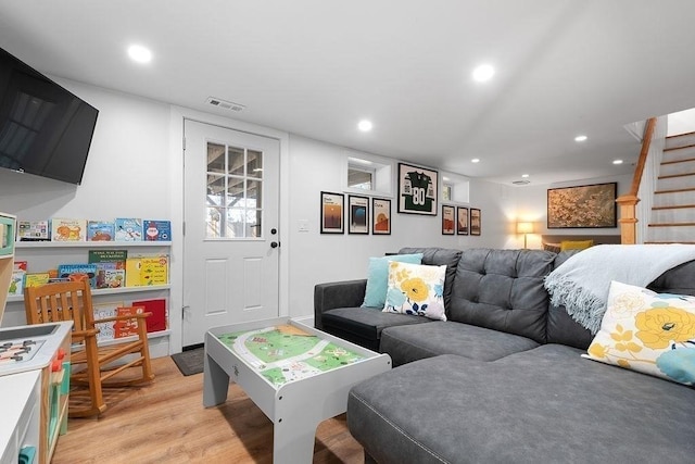 living area with visible vents, recessed lighting, stairs, and light wood-style floors