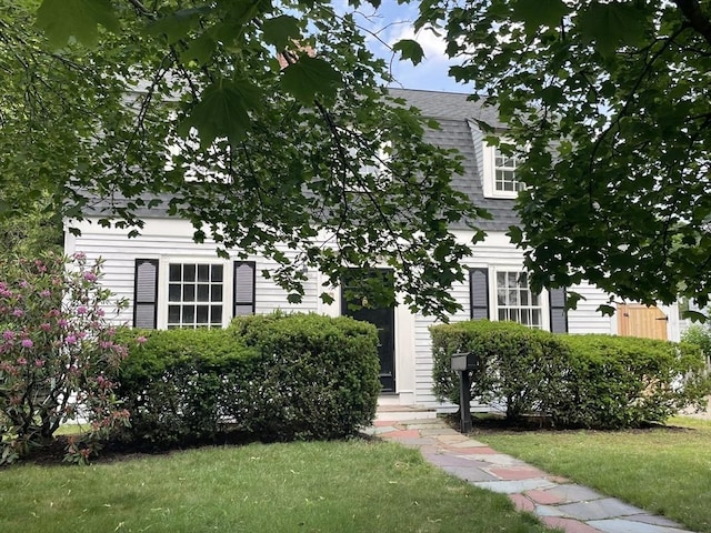 27 Fairway Dr, Newton, MA 02465 - view of property hidden behind natural elements with a front yard and a shingled roof