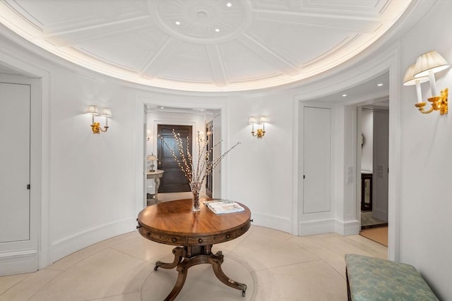 corridor with crown molding, tile patterned floors, baseboards, and coffered ceiling