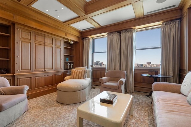 sitting room featuring wooden walls, crown molding, beam ceiling, built in shelves, and coffered ceiling
