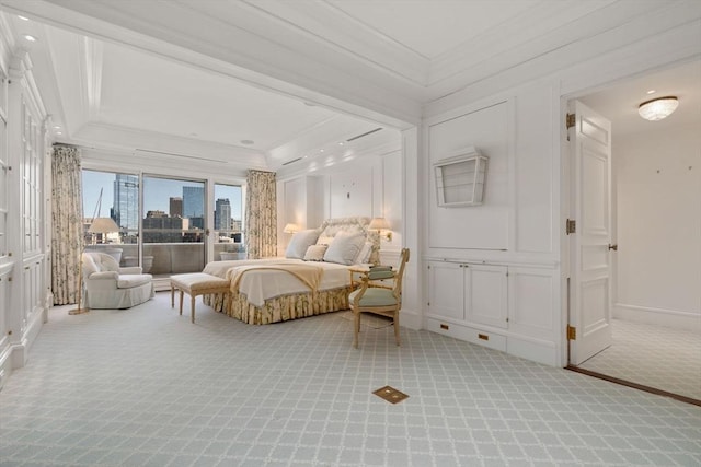 bedroom with carpet floors, a view of city, crown molding, a decorative wall, and access to exterior