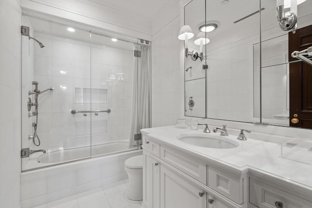 bathroom with vanity, tile patterned flooring, crown molding, toilet, and tiled shower / bath