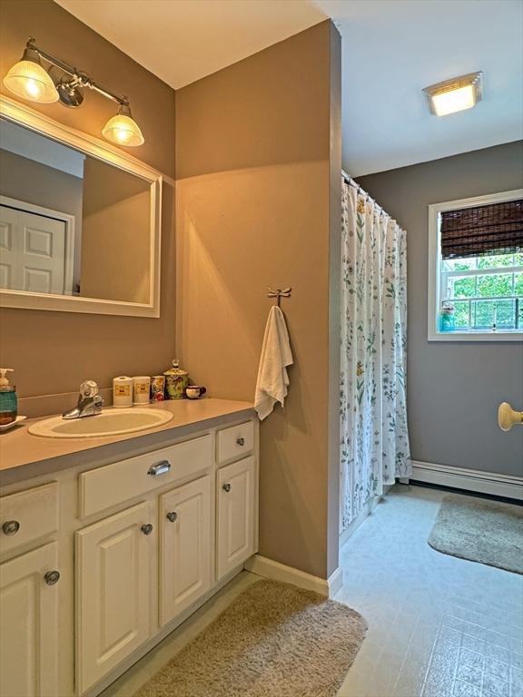 19 Orange Rd, Northfield, MA 01360 - bathroom featuring vanity, baseboard heating, and a shower with shower curtain