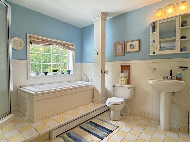 19 Orange Rd, Northfield, MA 01360 - bathroom with wainscoting, a garden tub, tile patterned flooring, a shower with door, and ornate columns