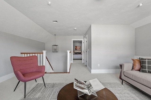 living area with lofted ceiling, carpet, and baseboards