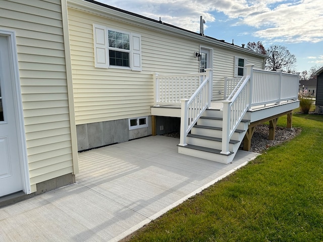 rear view of house featuring a lawn and a wooden deck