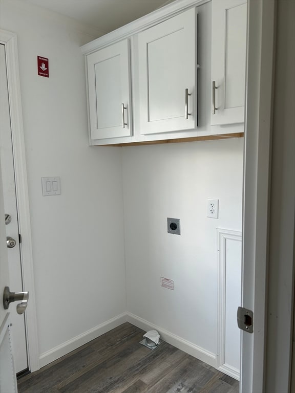 clothes washing area with cabinets, electric dryer hookup, and dark hardwood / wood-style floors