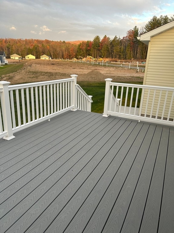 wooden terrace featuring a yard