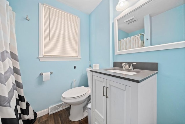 bathroom with hardwood / wood-style floors, toilet, and vanity