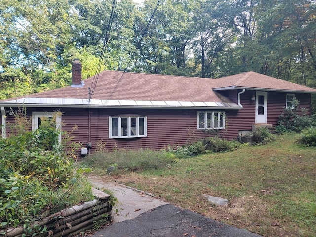 view of side of home with a yard