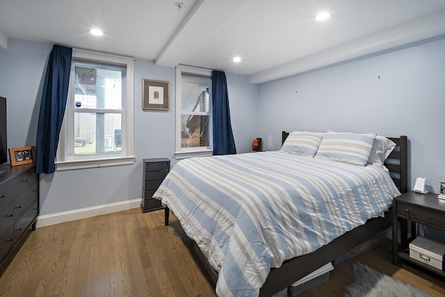 bedroom featuring wood finished floors, baseboards, and recessed lighting