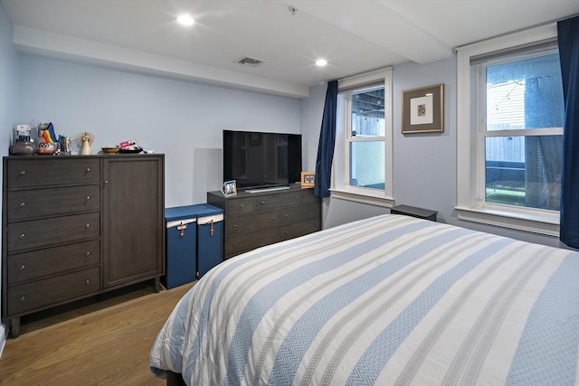 bedroom featuring wood finished floors and recessed lighting