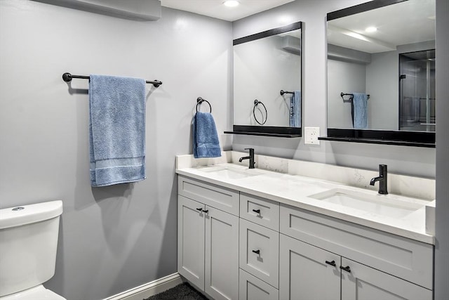 full bath with toilet, double vanity, baseboards, and recessed lighting