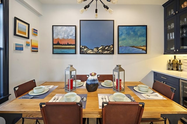 dining area featuring a chandelier and a dry bar