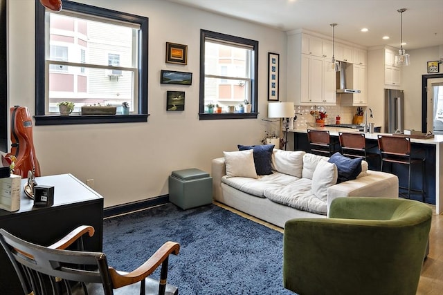 living area with recessed lighting and baseboards