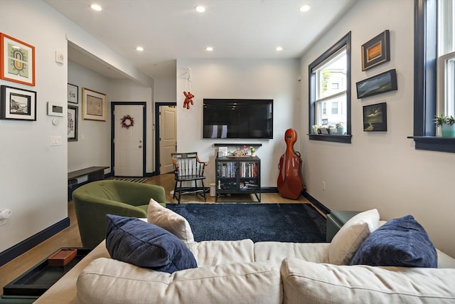 living area featuring recessed lighting and baseboards