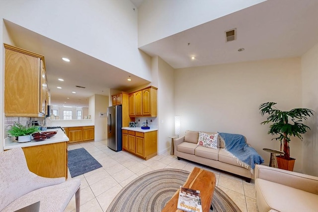 living area featuring light tile patterned floors, visible vents, and recessed lighting