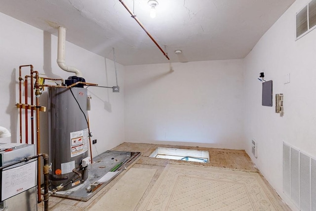 interior space featuring gas water heater and visible vents