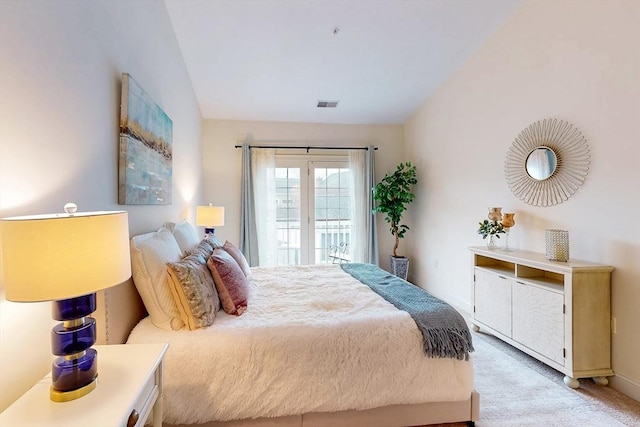 bedroom featuring light carpet, access to outside, visible vents, and vaulted ceiling