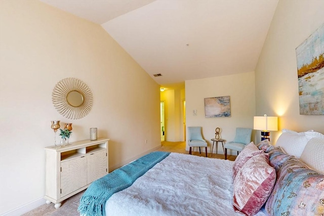 bedroom with visible vents, vaulted ceiling, and baseboards